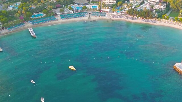 Avsallar, Alanya, Turkey. Intimate aerial view of bay coastline with sandy beaches and resort amenities at dusk.. Aerial View, MasterShots, Zoom In, Circle (Close)