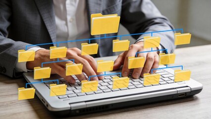 Person working on laptop with folder icons