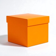 Fototapeta premium A square orange box with a lid sits centered on a bright white background, casting a soft shadow, highlighting its structure