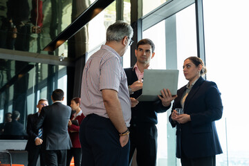Meeting and discussion concept.business people communicating in office.Mature businessman discuss information with a colleague in a modern business lounge high up in an office tower.