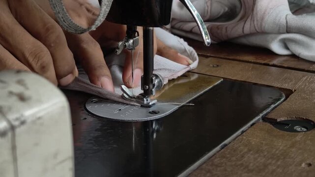 the hand sewing the textile neatly