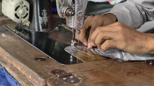 the hand sewing the textile neatly