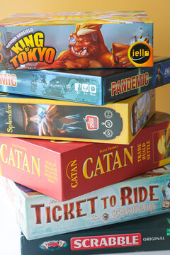 Tangerang, Indonesia - June 23, 2025: A vertical stack of popular and classic board games, showcasing a diverse collection of well-known titles.