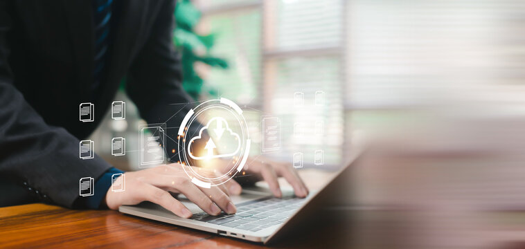 Business professional typing on laptop with cloud upload and document icons, representing secure cloud computing, data storage, digital workflow, online backup, cybersecurity, and office technology. - Powered by Adobe