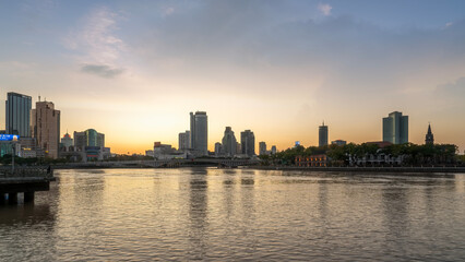 Fototapeta premium Riverside City Skyline at Sunset