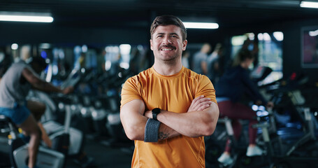Fitness, portrait or man in gym with arms crossed, pride or progress in physical exercise. Happy, space or athlete in center with confidence, training break or workout results in body improvement.