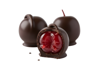 Three chocolate-covered cherries set against a white background, complete with a clipping path. The image features a shallow depth of field, focusing on the bitten part of the truffle that reveals
