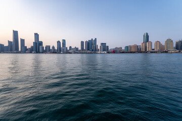 Fototapeta premium City Skyline Along Calm Ocean Waters