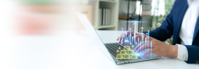 Gold Market Growth and Digital Investment. Typing on a laptop with glowing gold bars and rising charts, representing gold market growth, digital investment, financial analysis and wealth expansion.
