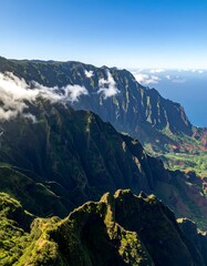 Fototapeta premium A lush green mountain range under a blue sky with clouds