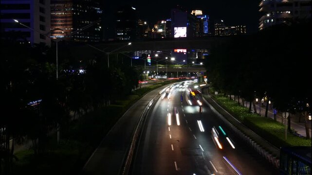 Night Timelapse of Busy Traffic Light Trails and City Lights at Sudirman Business District