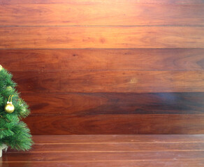 A beautifully decorated Christmas tree on a wooden background.