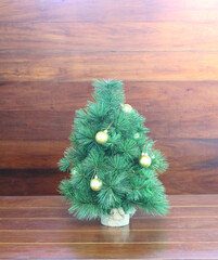 A beautifully decorated Christmas tree on a wooden background.