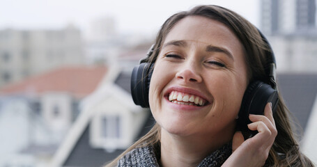 Headphones, happy and woman on balcony with music for calm, peace and relax in morning on weekend. Audio tech, smile and female person listening to playlist, radio or album online outdoor of home.