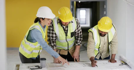 Fototapete Altes Krankenhaus Beelitz People, architect and blueprint with team at meeting, writing and point with solution for building. Group, contractor and engineer with floor plan, talk and insight at property development company  © peopleimages.com