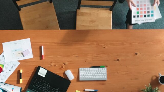 Top down view of smart businessman hand choosing color palettes while designing logo graphic. Aerial view of smart interior designer design and select color theme by using color palettes. Symposium.