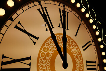 Vintage clock with Roman numerals showing midnight time close-up