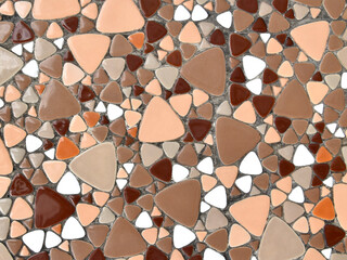 irregular pattern of warm earth tone colours triangular mosaic tiles