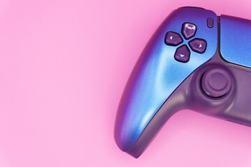 A gamepad for consoles on a pink background, gaming addiction, gaming ban for teenagers, gaming controls for parents, for banners and advertising. High quality © Karen Vardanian