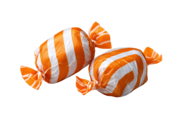 Two orange and white striped candies wrapped in cellophane on black background candy sweets