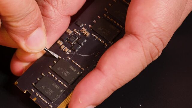 Macro View of Technician Repairing Computer RAM Module with Precision Tool