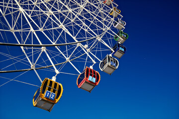 Colorful Ferris wheel cabins close up, amusement park ride details