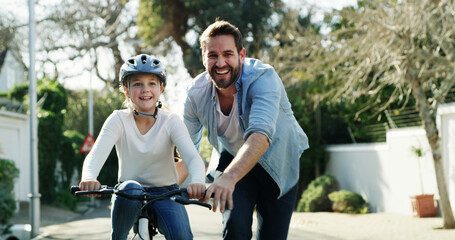 Father, daughter and bicycle in street with help, training lesson and safety helmet for protection....