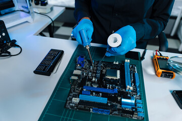 Hands repairing electronic devices. Electronic technician.