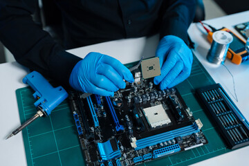 Hands repairing electronic devices. Electronic technician.