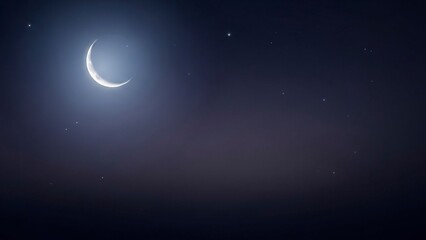 Fototapeta premium Crescent moon in a dark sky speckled with scattered stars
