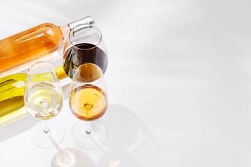 Obraz premium Different wine bottles and glasses on white background