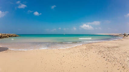 Fototapeta premium Serene Beach with Turquoise Waters and Clear Blue Sky