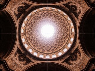 A large ornate dome with a light shining through it