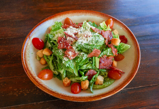 caesar salad on ceramic plate in restaurant