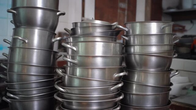 The Stack of Empty Suhoor Pots. Islamic Culture &ndash; Idul Fitri. Stack of pots and pans in the kitchen, signaling the temporary end of the nightly Suhoor ritual and the transition to the day of feasting.