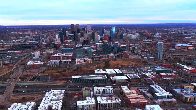 Downtown Denver Lodo skyline cityscape skyscrapers buildings winter Colorado aerial drone landscape grey sky sunset afternoon neighborhood i25 traffic cars highway front range circle right motion