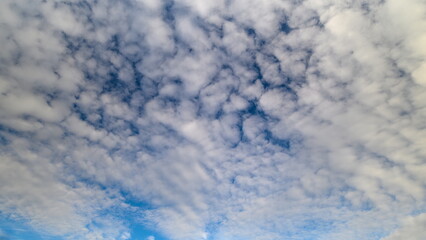 Expansive sky scenes featuring textured clouds and serene ambiance, Wide sky landscapes showcasing moving clouds and subtle light and shadow interplay for background effects