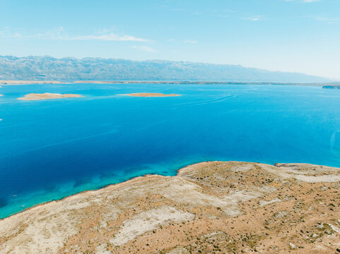 Vrsi near Zadar archipelago cove beach in stone desert scenery near Zecevo island, Dalmatia in Croatia and Pag Island in background.