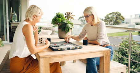 Board game, relax and strategy with senior friends on home balcony together for bonding or...