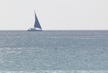 Fototapeta premium A sailboat is sailing in the ocean