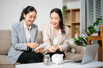 Happy businesswomen celebrating success at home office. Teamwork, financial growth, achievement, motivation and positive business result