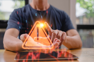 A man holding virtual triangle warning sign in concept of cyber security in social internet network, representing a cyber security threat, data protection alert, or system error