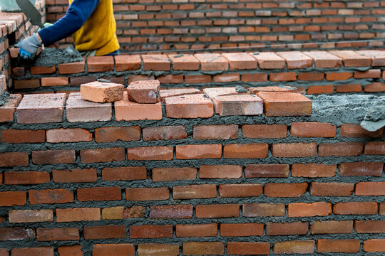 Close up of bricklayer building walls