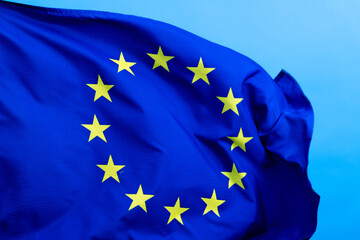 European Union Flag waving on blue background