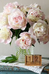Pink peonies blooming with march 12 wooden calendar