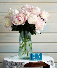Pink peonies bouquet in vase celebrating march 5th