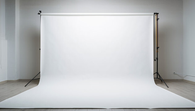Spacious empty photography studio featuring a professional white backdrop and lighting equipment, ideal for versatile creative projects
