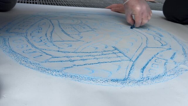 Fast motion timelapse: Artists trace street drain cover with charcoal