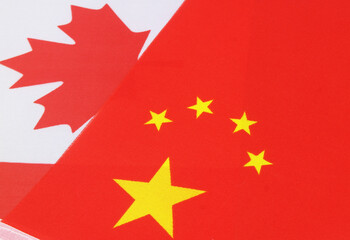 Fototapeta premium Chinese and Canadian flags close-up. Relationship of China and Canada.