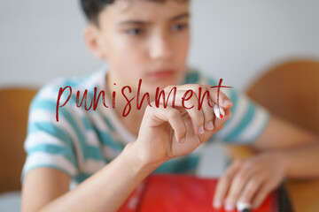punishment concept. Teenager student writing the word on the screen with a red marker.